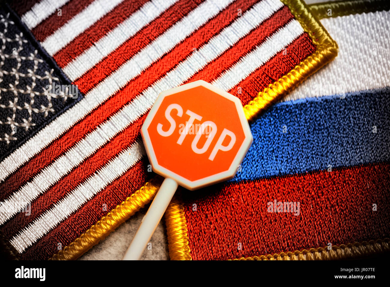 Stop sign in front of flags of the USA and Russia, US sanctions Stock