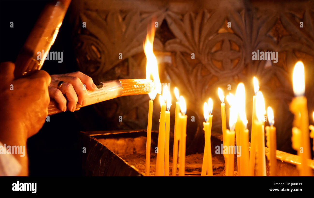 Prayers lighting candles in Holy Sepulcher Church Stock Photo Alamy