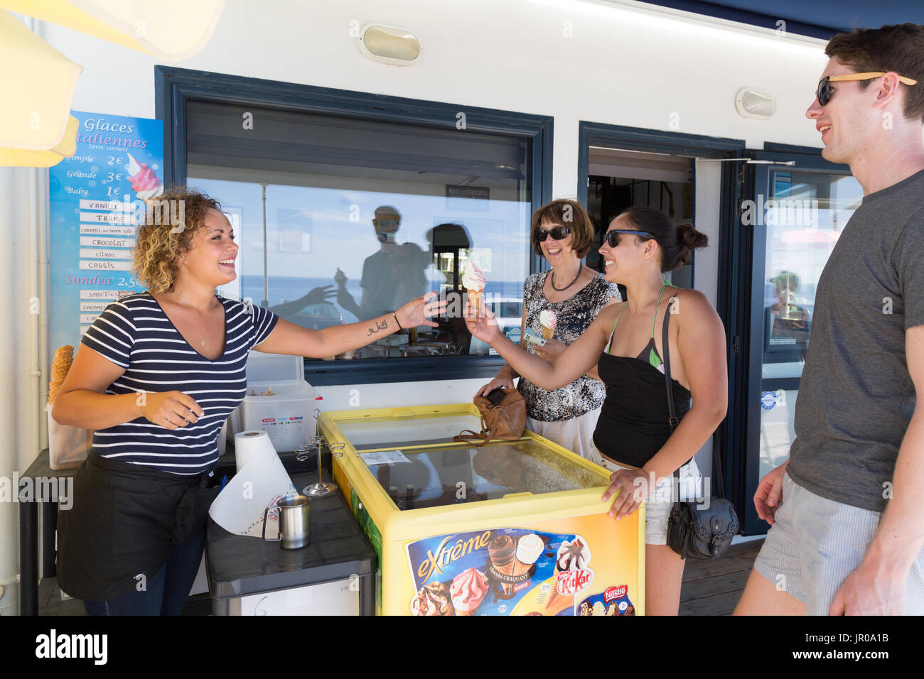 Tourists buying ice cream from a stallholder, Trevignon, Finistere, Brittany France Europe Stock Photo