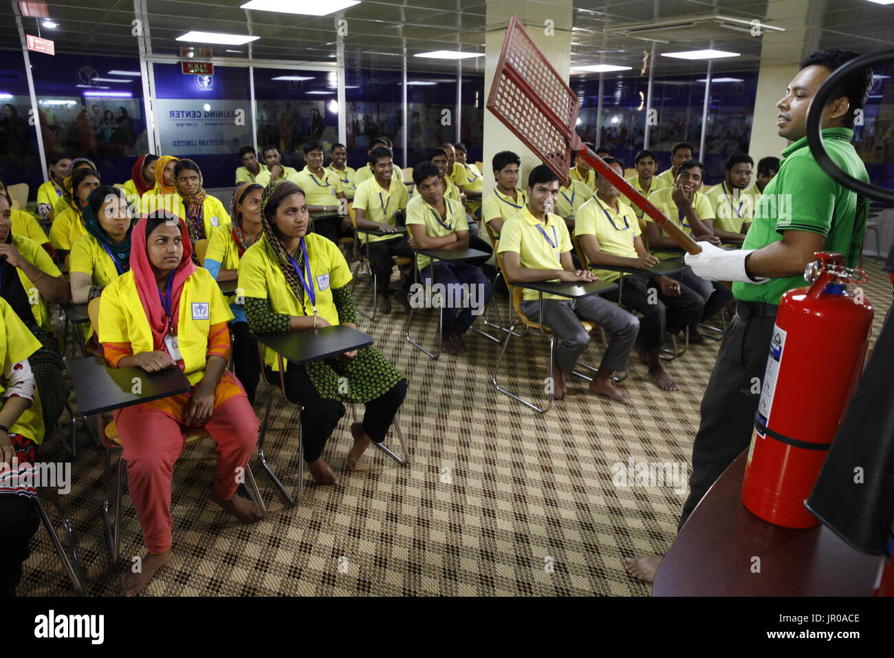 Readymade garment workers participate in a fire fighting training session for their safety in a