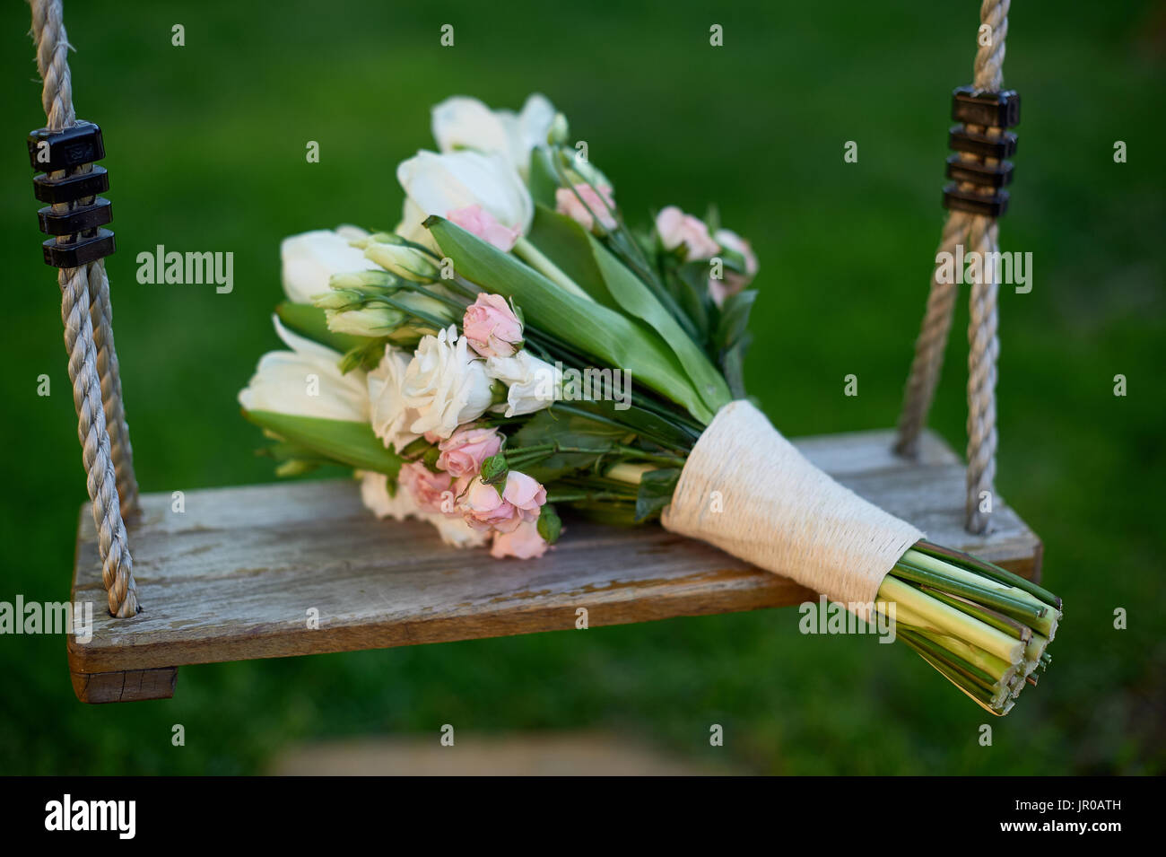 Bridal bouquet is on a swing Stock Photo