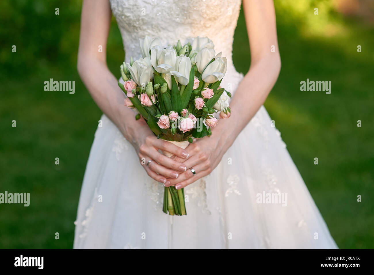 bride is holding a wedding bouquet of flowers Stock Photo