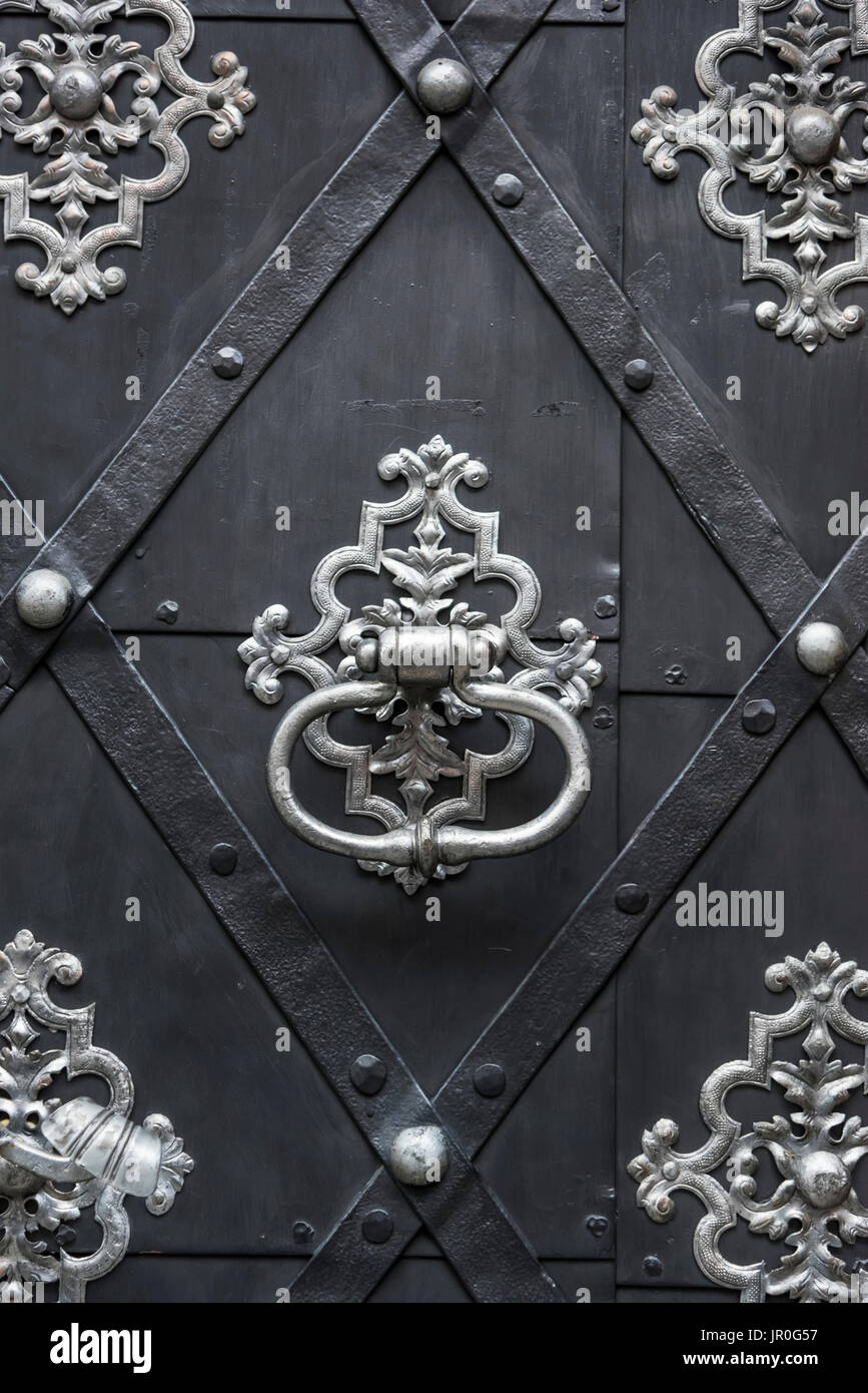 Close-Up Detail Of The Architectural Detail Of A Door With Silver Knocker; Prague, Czech Republic Stock Photo