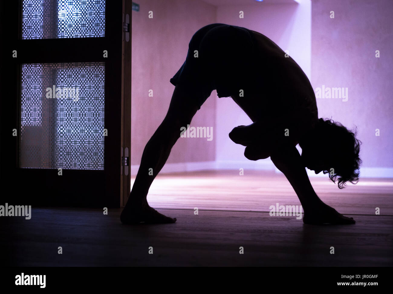 Male yoga teacher doing handstand calisthenics and yoga asana practice