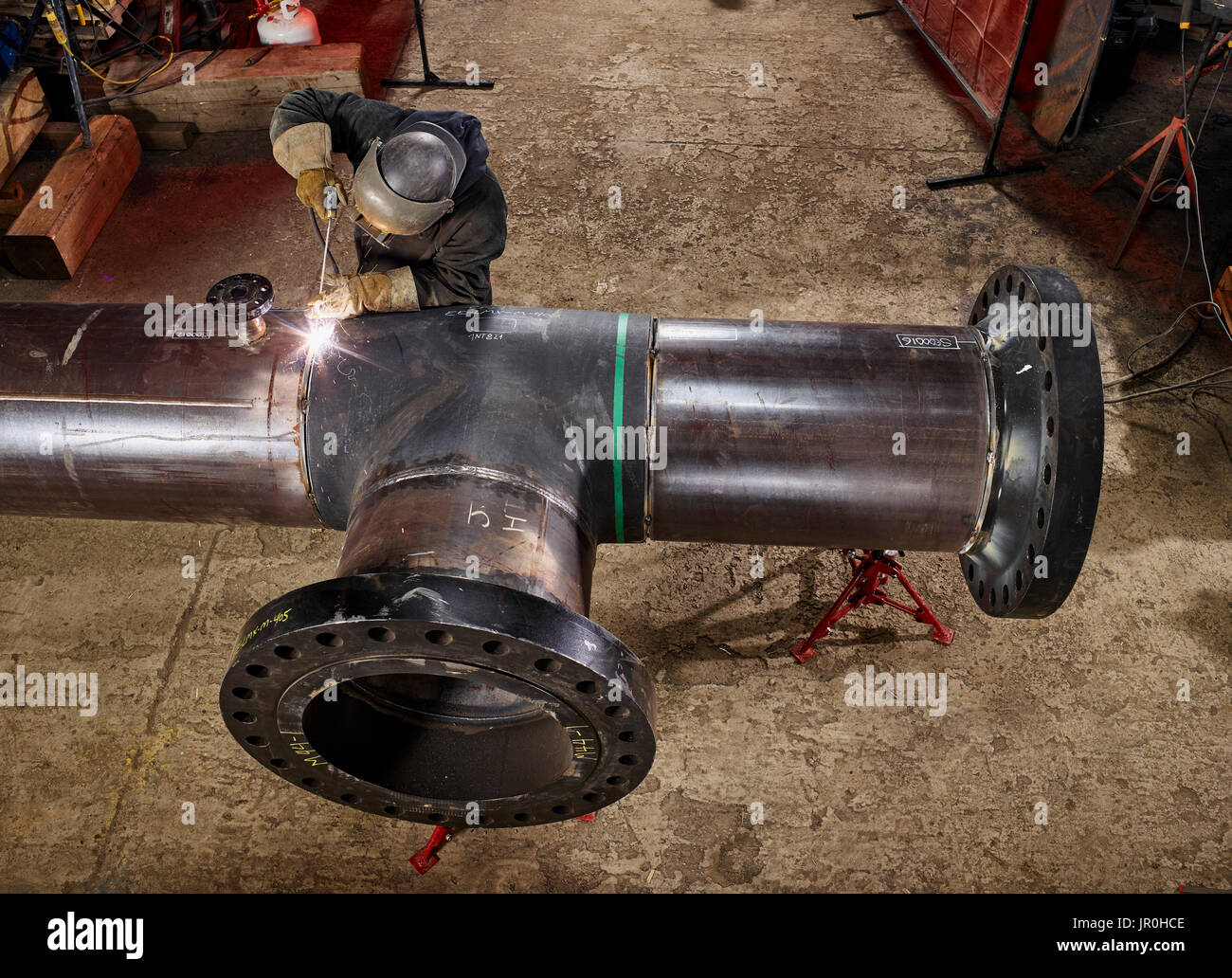 A Welder Works On Welding The Joints Of Pipes; Edmonton, Alberta