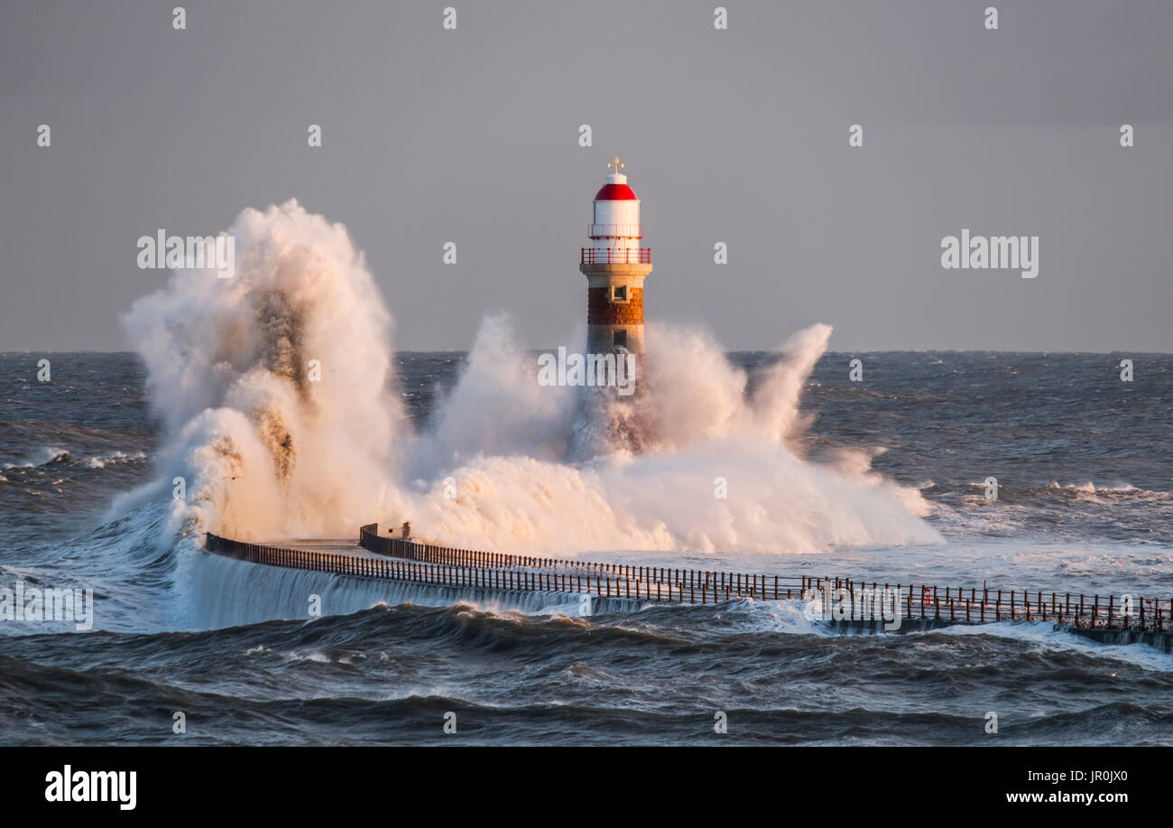 Waves Splashing Against Roker Lighthouse At The End Of A Pier; Sunderland, Tyne And Wear, England Stock Photo