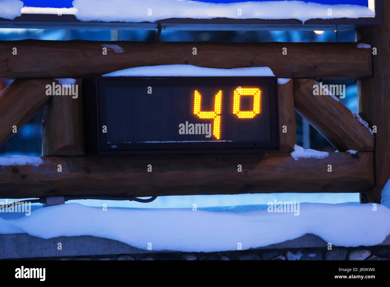An Outdoor Digital Thermometer In The Snow In Winter Measuring Four Degrees Fahrenheit; Alaska, United States Of America Stock Photo
