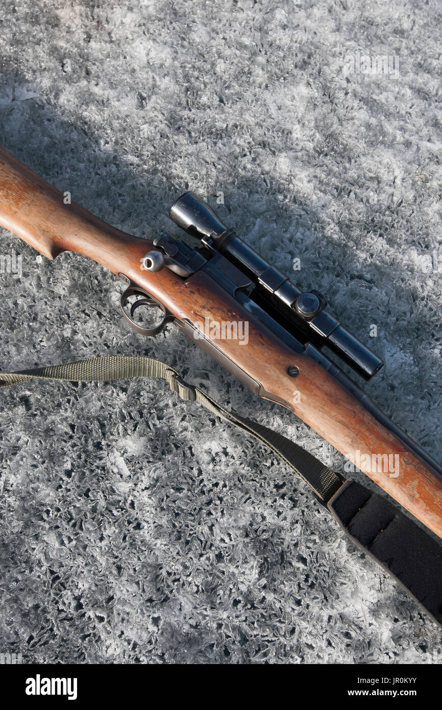 A Rifle With Telescope And Strap Used For A Seal Hunt Laying On The Ice; Alaska, United States Of America Stock Photo