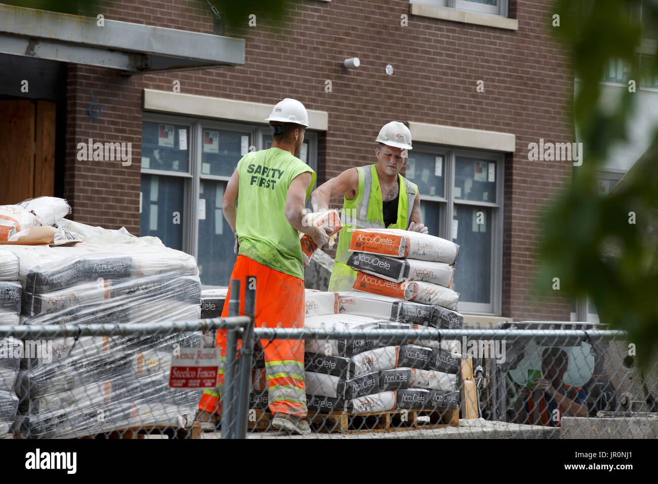 Construction workers mixing cement Stock Photo