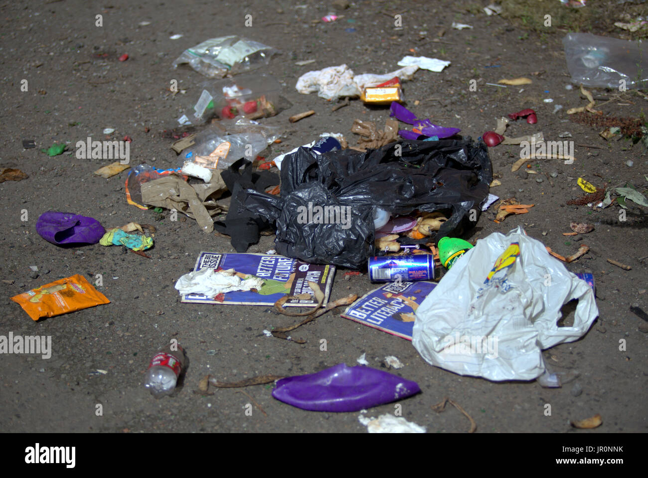 the big issue cover  better literacy leaflets Govanhill Glasgow fly tipping rubbish on street Stock Photo