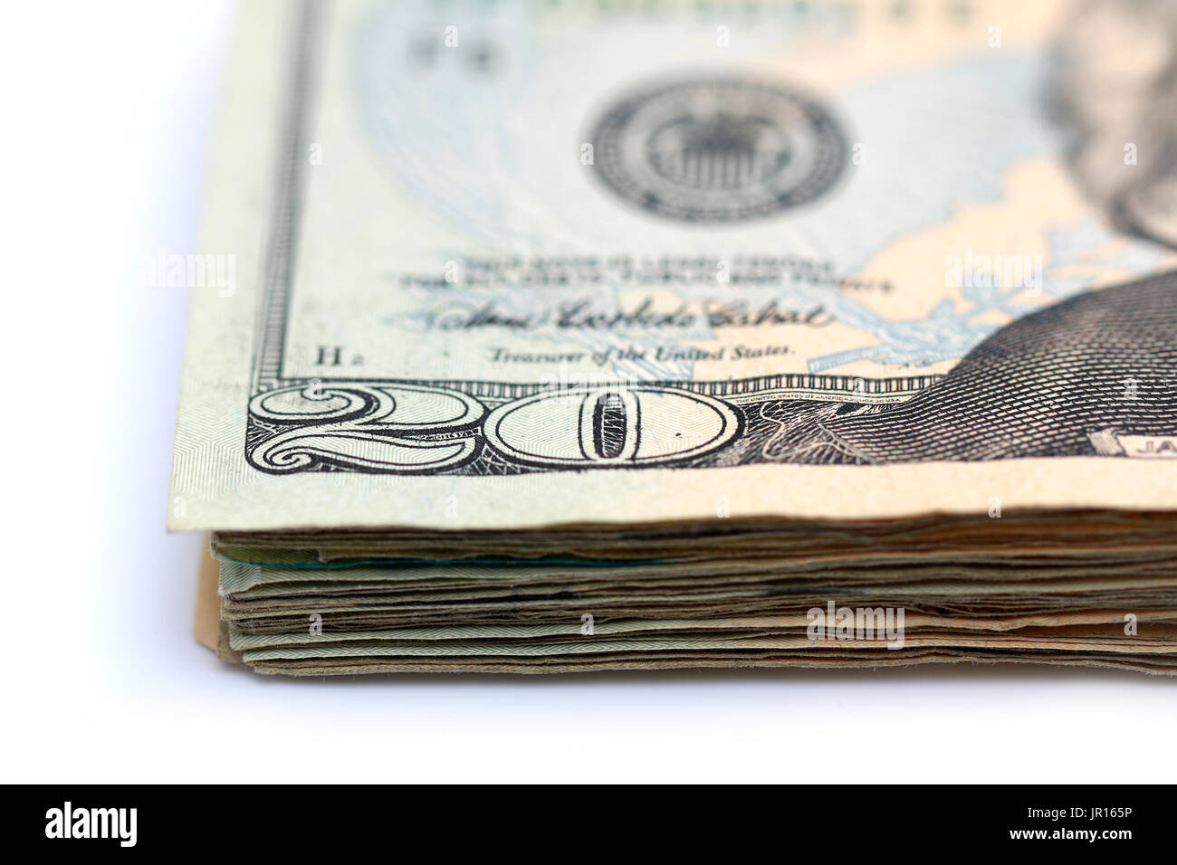 A stack of twenty dollar bills isolated on a white background Stock Photo