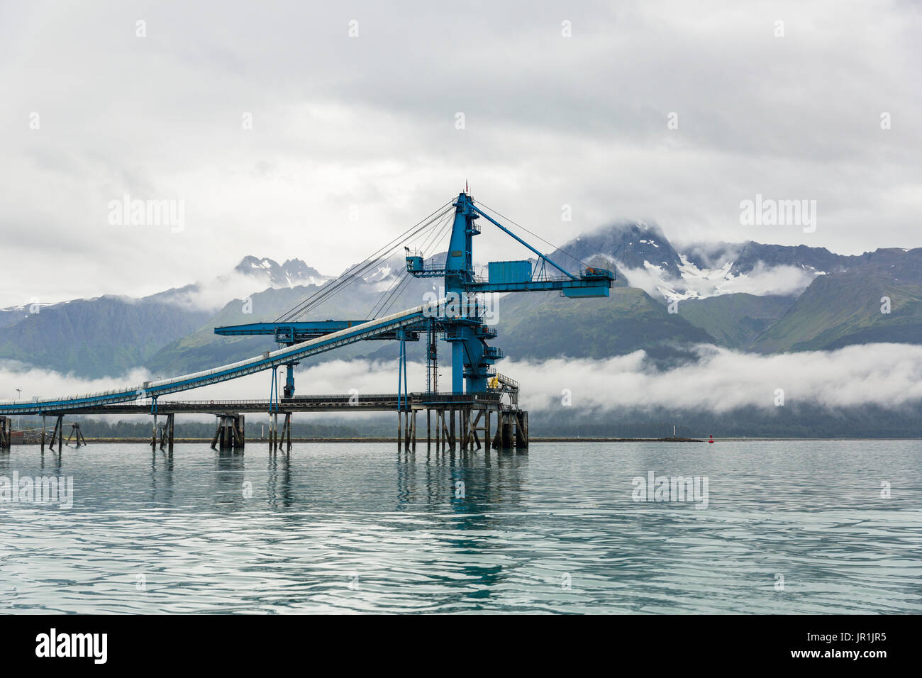 Coal Loading Terminal With Kenai Mountains In The Background And Low Lying Clouds, Seward, Southcentral Alaska, USA Stock Photo