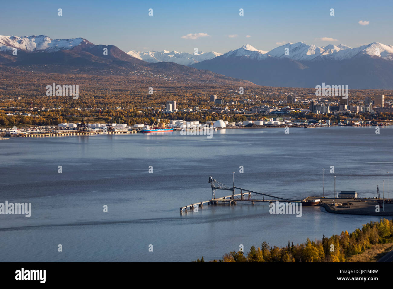 Aerial View Of Point Mackenzie Dock With Anchorage And The Chugach Mountains In The Background, Southcentral Alaska, USA Stock Photo