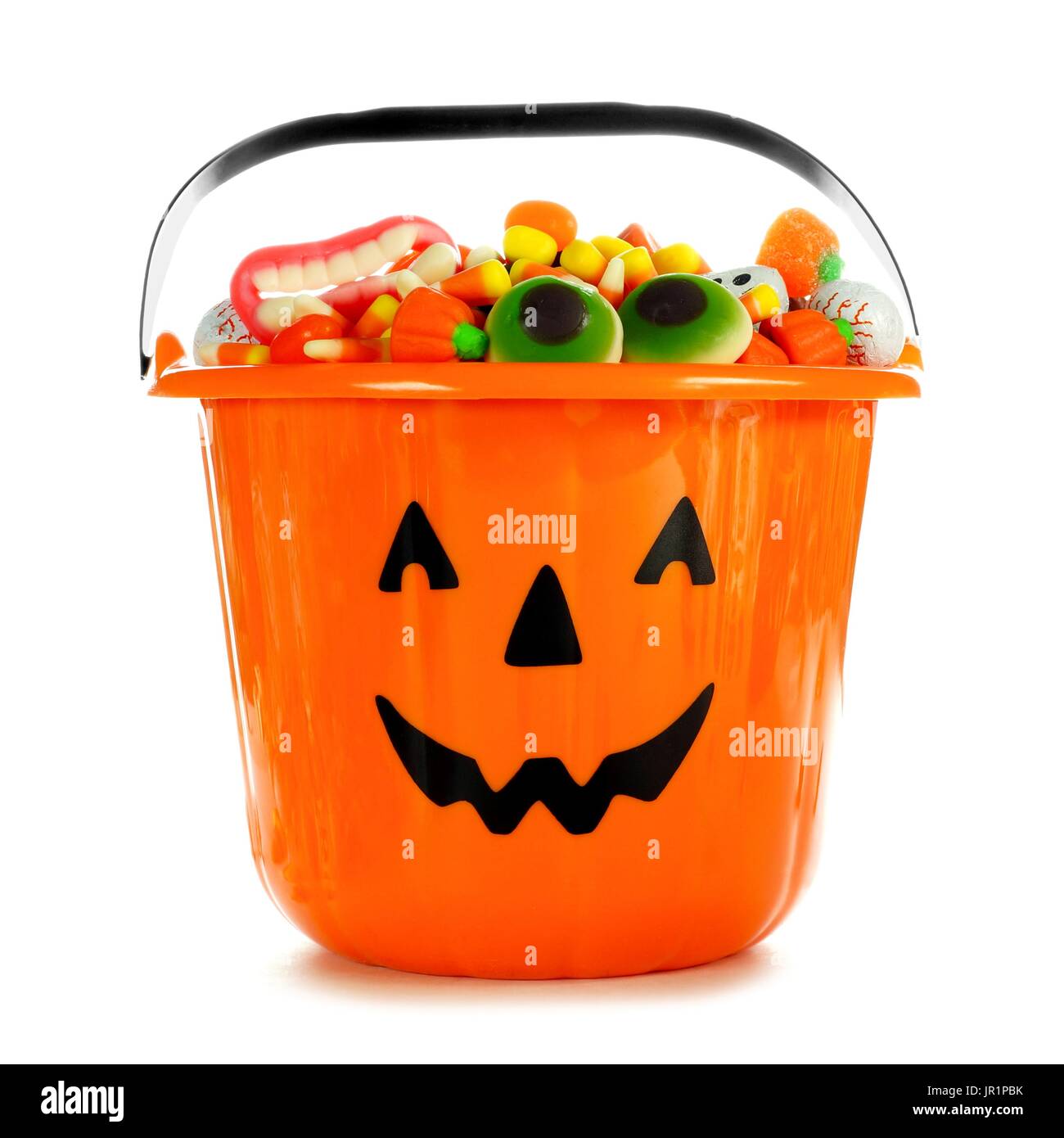 Halloween Jack o Lantern candy collector filled with candy over a white