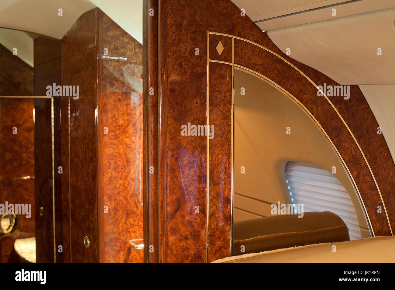 Wood trim with gold inlay and mirror in Lear 60 jet aircraft Stock Photo