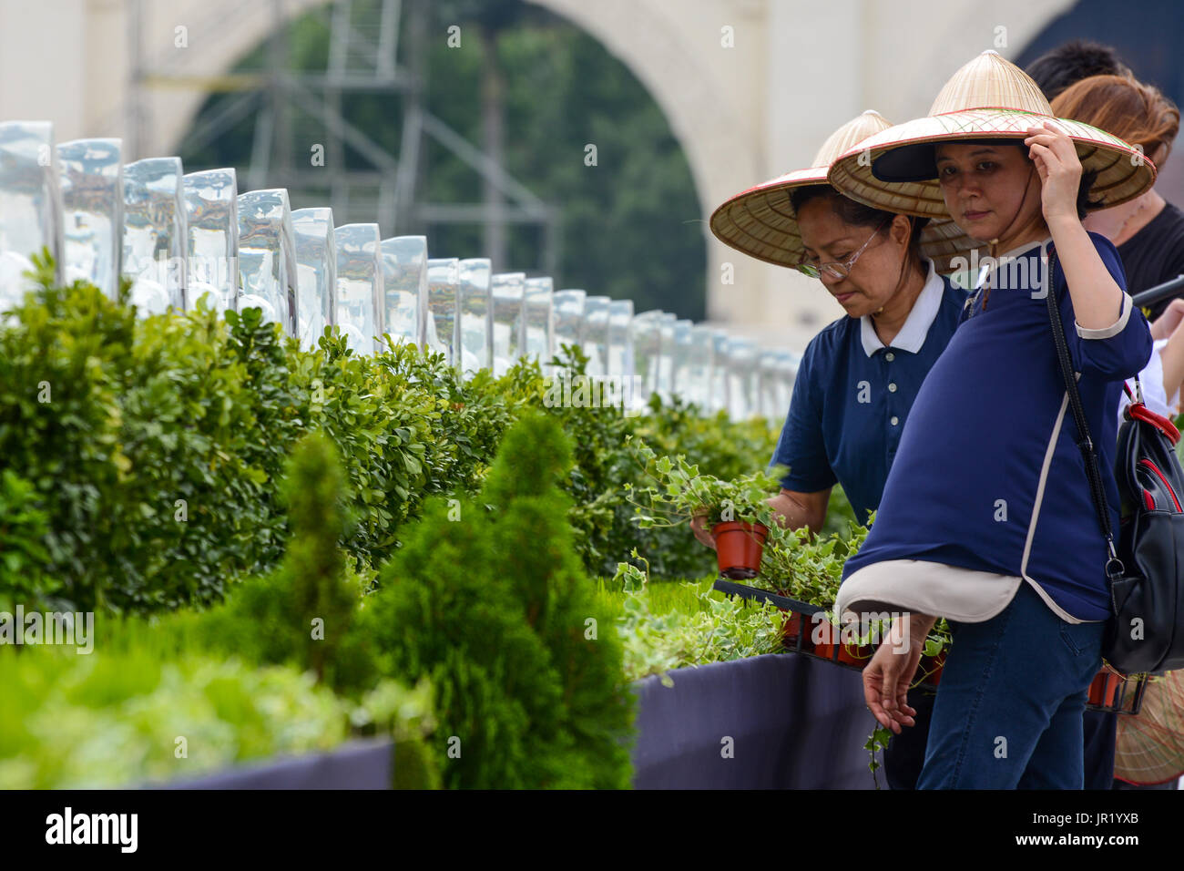 TAIPEI, TAIWAN - MAY 14, 2017 - Women from the Buddhist Tzu Chi Foundation prepare decorations for the annual celebration in Taipei Stock Photo