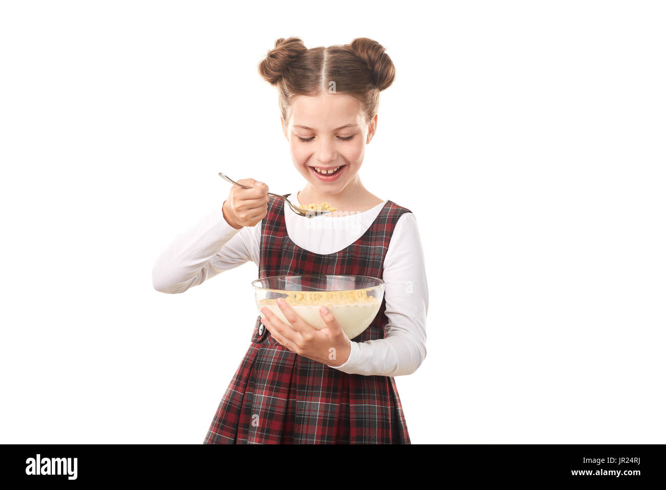 School girl eating cereal with milk Stock Photo Alamy