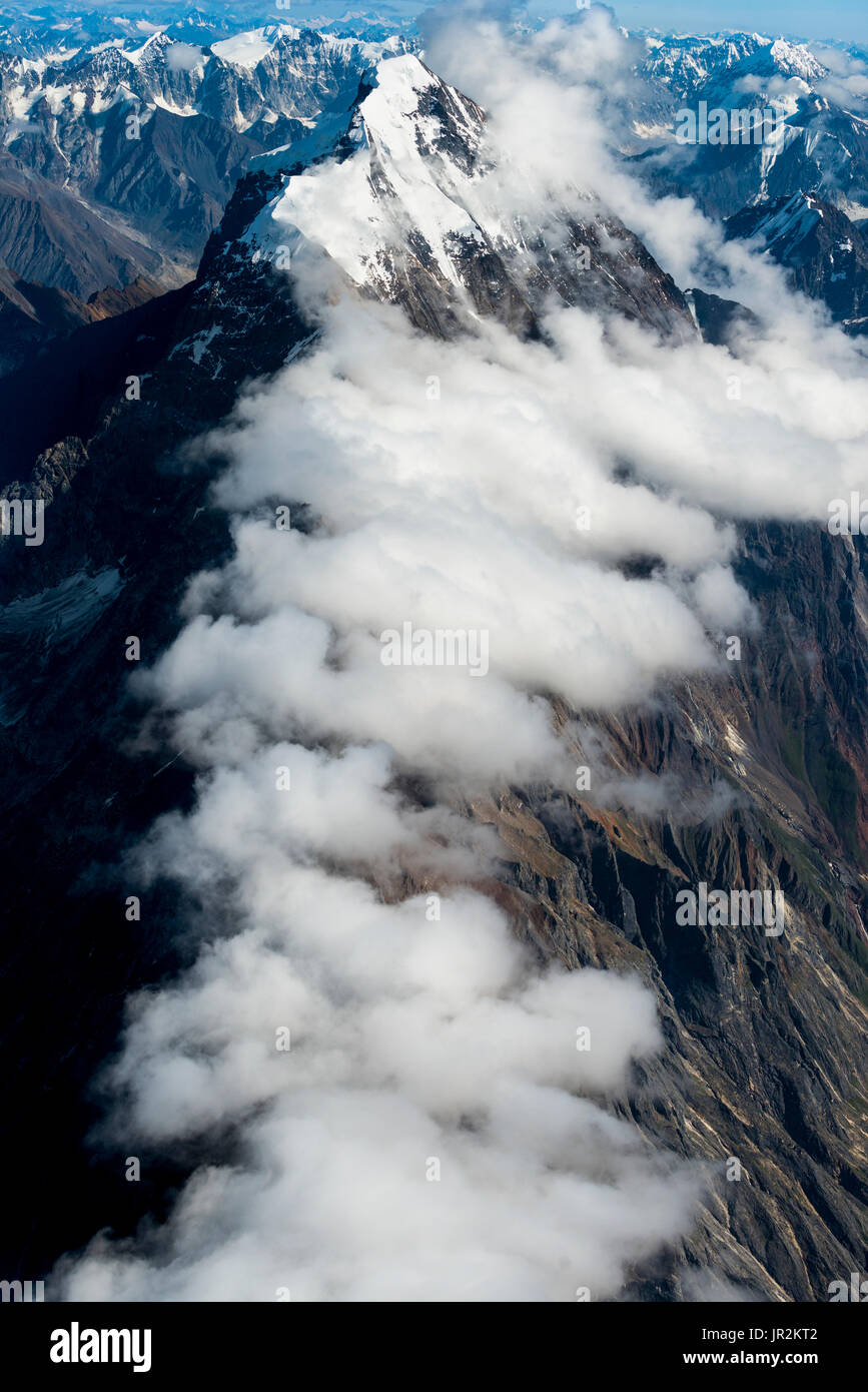 Aerial Scenic Of A Cloud Shrouded Peak In The Alaska Range, Interior Alaska, USA Stock Photo