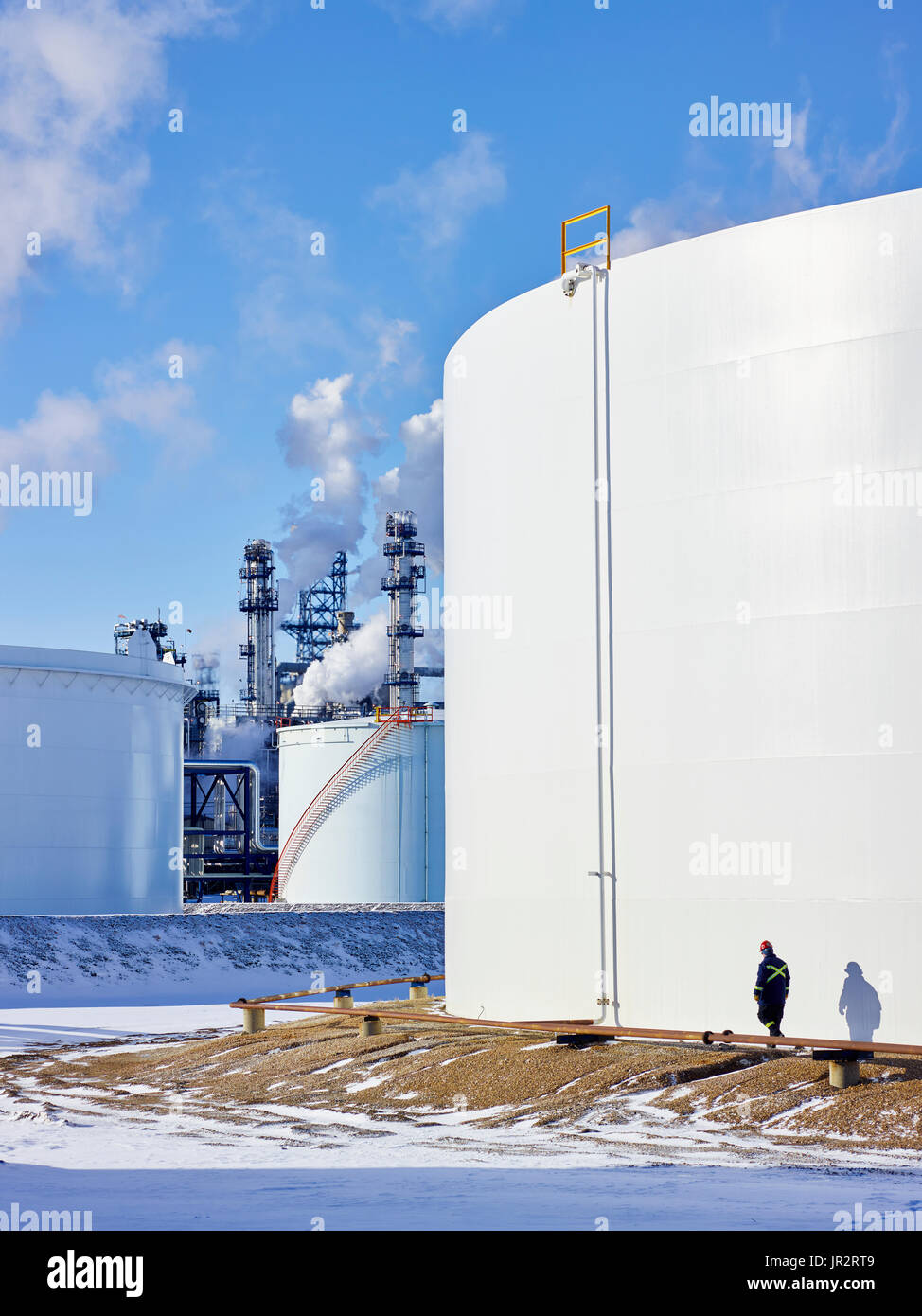 Tradesman Working At A Large, White Storage Tank; Edmonton, Alberta