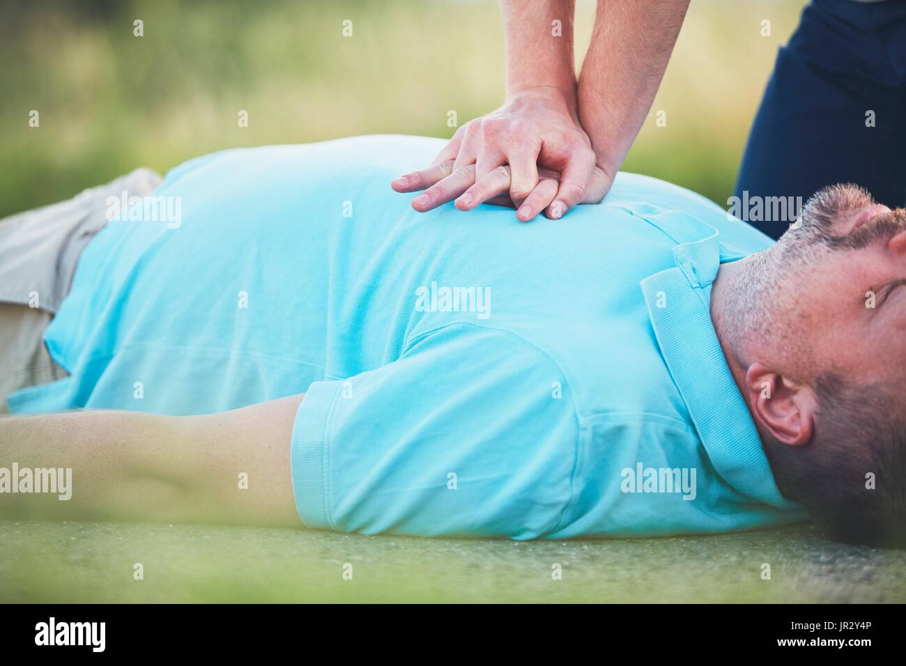 Dramatic resuscitation on the rural road. Themes rescue, help and hope. Stock Photo