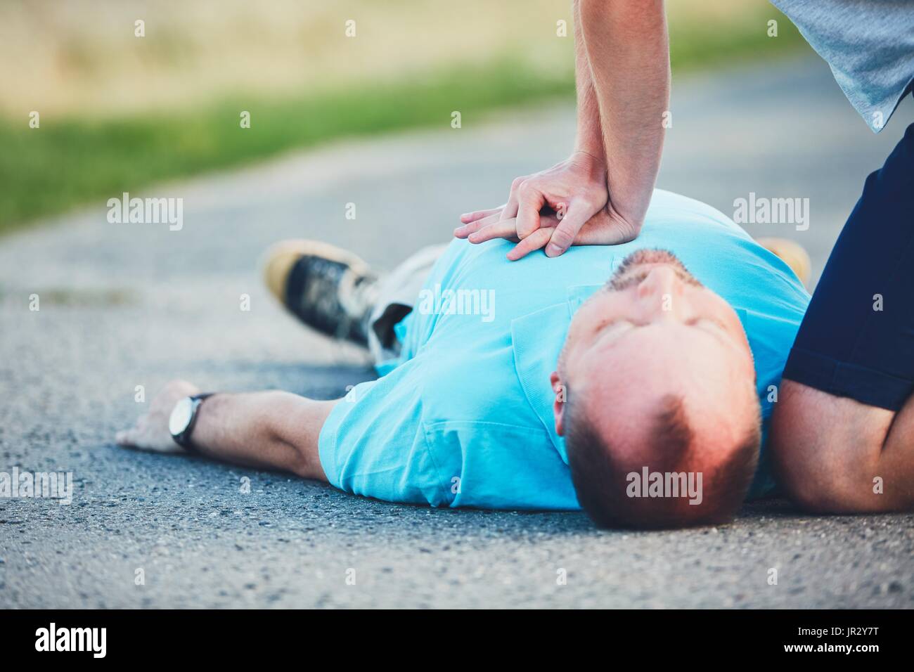 Dramatic resuscitation on the rural road. Themes rescue, help and hope. Stock Photo