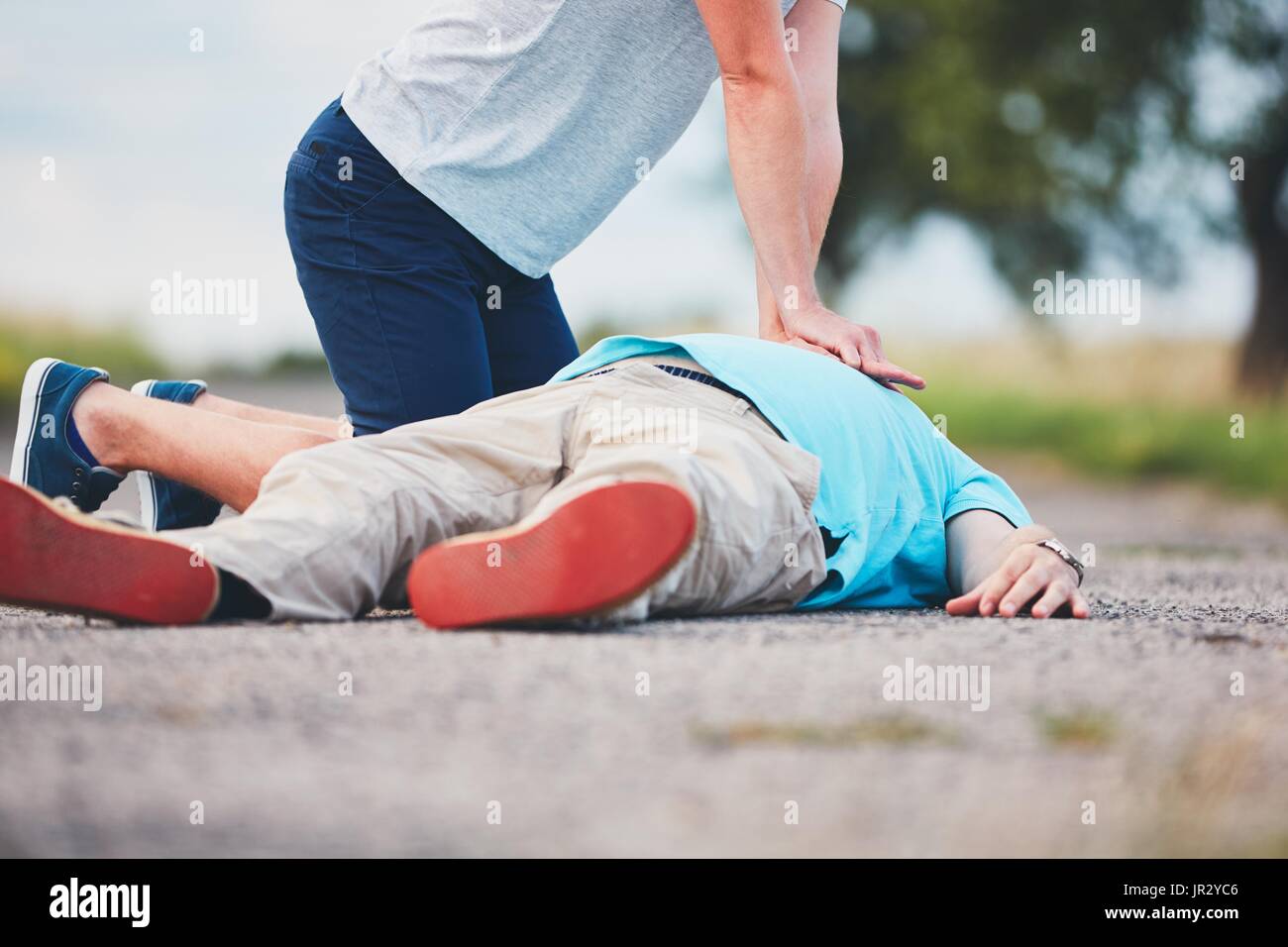 Dramatic resuscitation on the rural road. Themes rescue, help and hope. Stock Photo