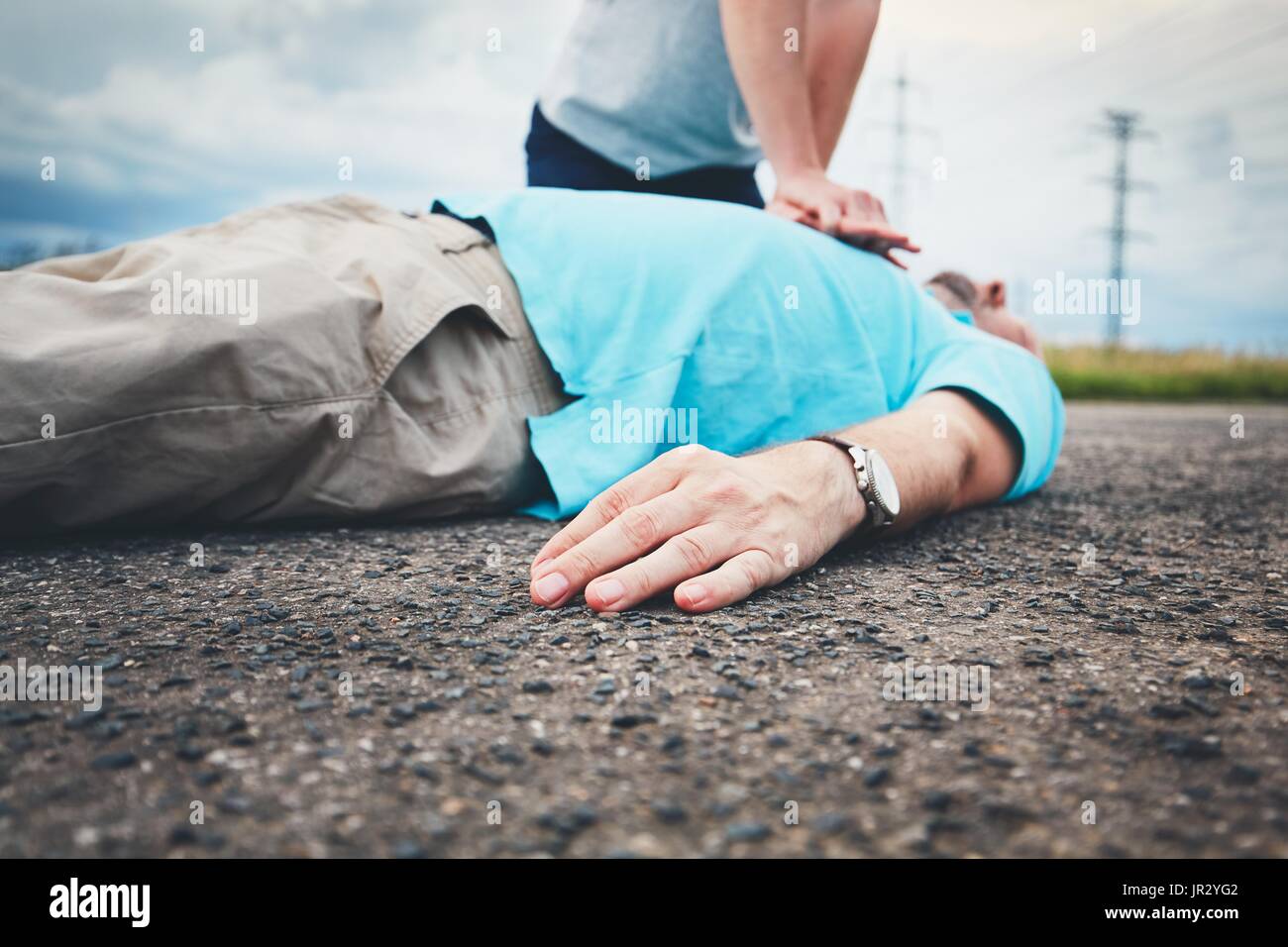 Dramatic resuscitation on the rural road. Themes rescue, help and hope. Stock Photo