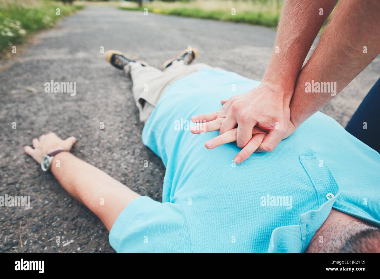 Dramatic resuscitation on the rural road. Themes rescue, help and hope. Stock Photo