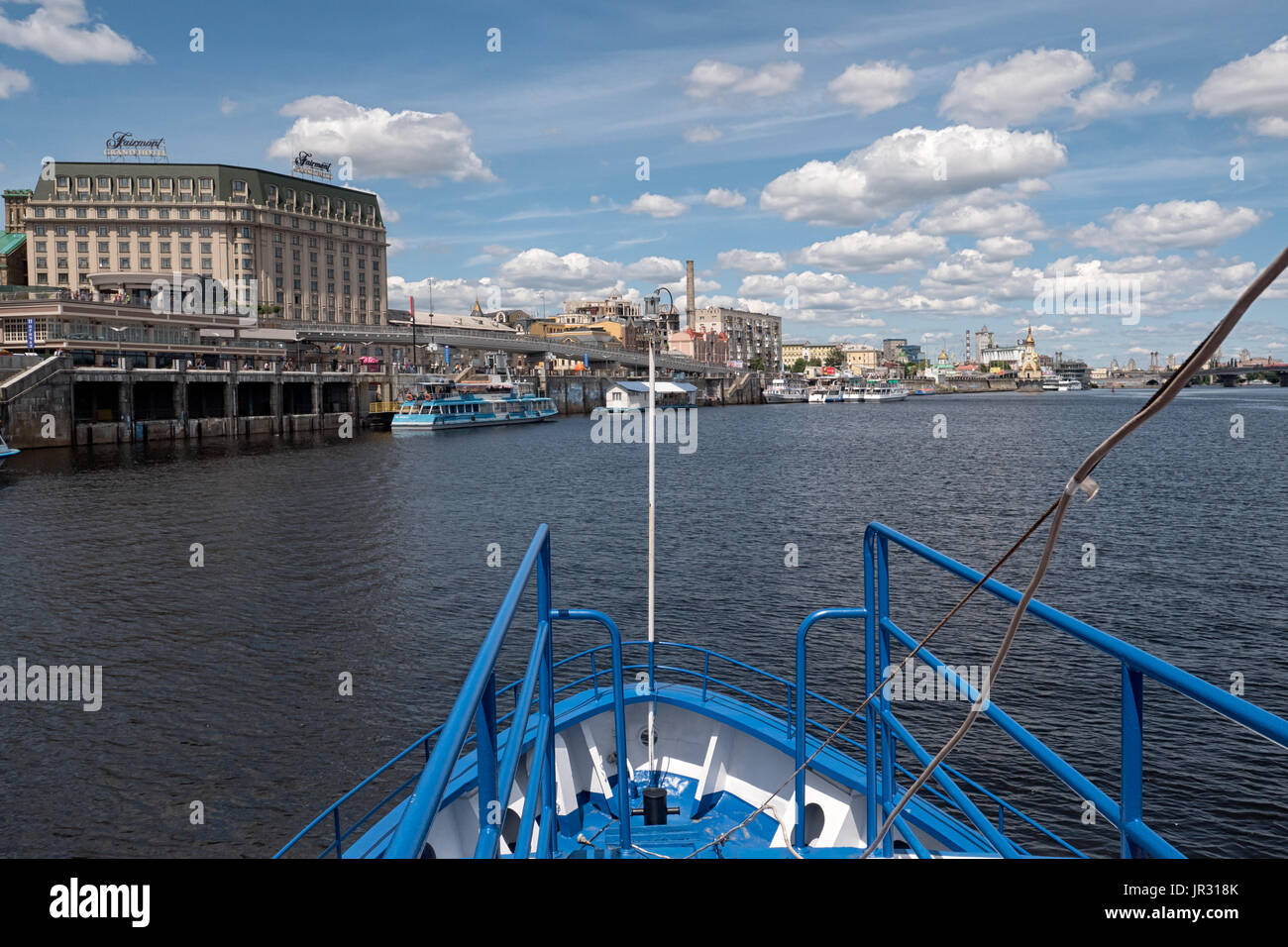 KYIV, UKRAINE - JUNE 12, 2016:  Bow of Tourist Boat in the River Port with the Fairmont Grand Hotel in the background on the Dnieper (Dnipro) River Stock Photo