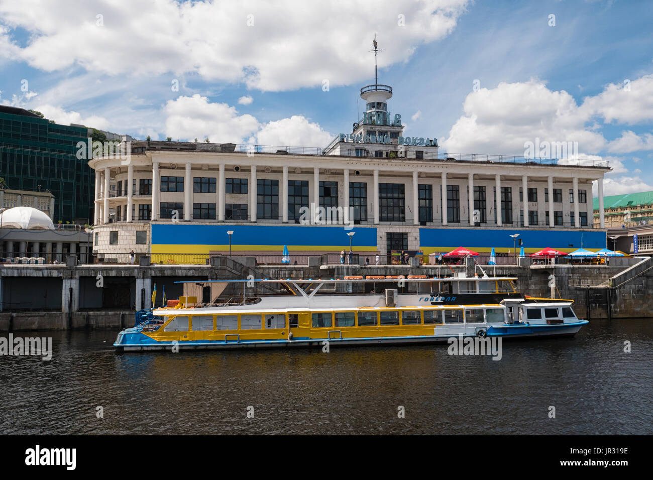 KYIV, UKRAINE - JUNE 12, 2016:  Tourist Excursion boat in front of the Kiev River Port Building on the Dnieper (Dnipro) River in the Podil District Stock Photo