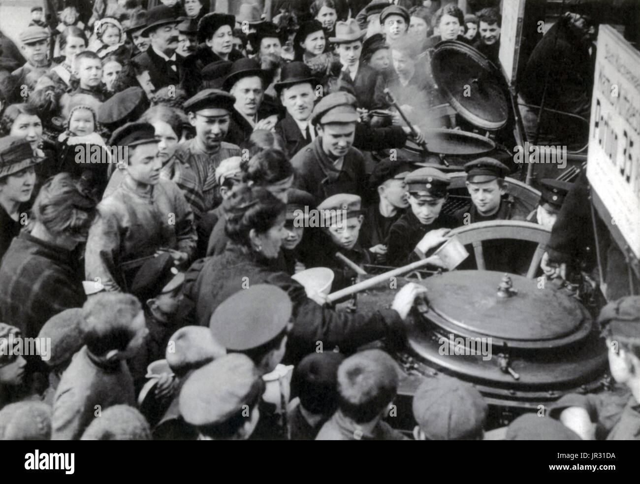 People waiting for soup in Berlin, 1916. The Blockade of Germany, from 1914-19, was a prolonged naval operation conducted by the Allied Powers during and after WWI in an effort to restrict the maritime supply of goods to the Central Powers. It is considered one of the key elements in the eventual Allied victory in the war. The German government made strong attempts to counter the effects of the blockade; a complicated rationing system initially introduced in January 1915 aimed to ensure that a minimum nutritional need was met, with 'war kitchens' providing cheap mass meals to impoverished civi Stock Photo