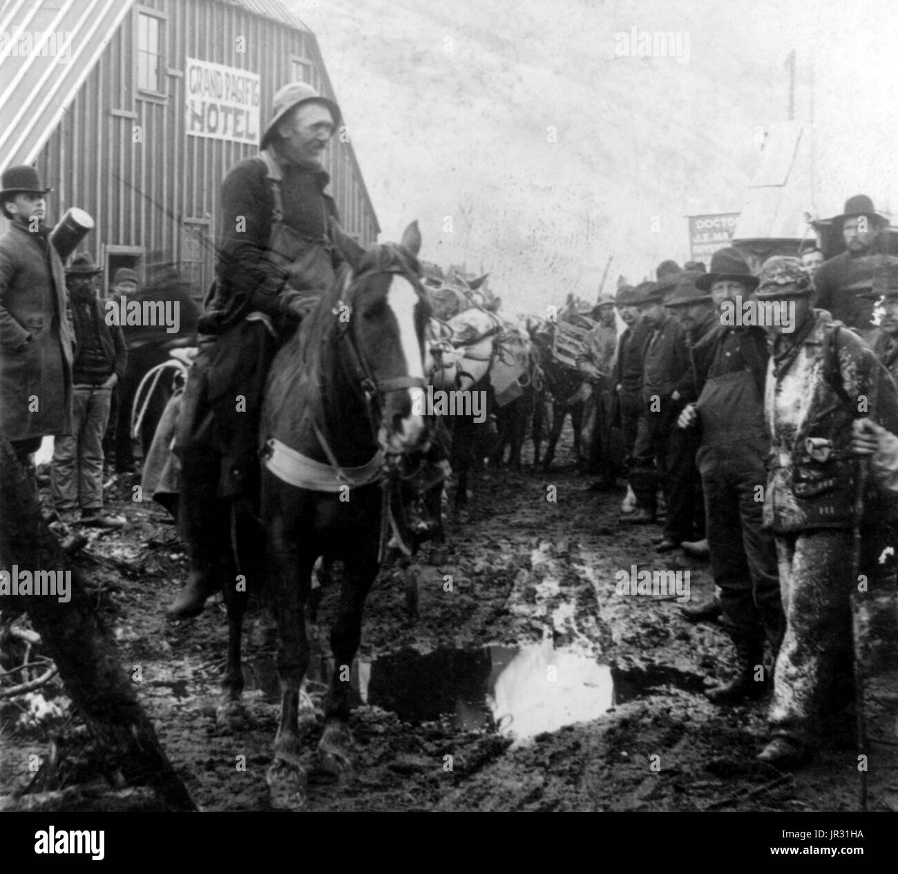 Grand Pacific Hotel. Party en route to the Klondike, Sheep Camp, Alaska. The Klondike Gold Rush was a migration by an estimated 100,000 prospectors to the Klondike region of the Yukon between 1896-99. Gold was discovered by local miners on August 16, 1896 and, when news reached Seattle and San Francisco, it triggered a stampede of would-be prospectors. To reach the gold fields most took the route through the ports of Dyea and Skagway in Alaska. Here, the Klondikers could follow either the Chilkoot or the White Pass trails to the Yukon River and sail down to the Klondike. Each of them was requi Stock Photo