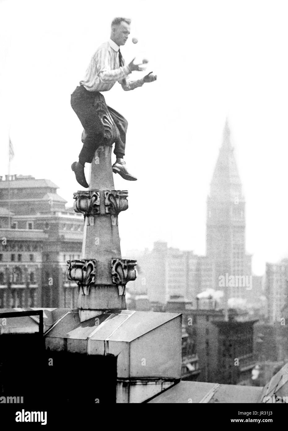 'Human Fly' Reynolds on a roof decoration in New York City. John 'Jammie' Reynolds (born 1890 or 91 - ?) was an American daredevil. Little is known about early life, what became of him once he stopped performing or even his real name. An acrobat and juggler, he was known by many names - Daredevil Johnny, Daredevil Jack, the Climbing Wonder, The Lizard, the Human Spider, and the Human Fly. A newspaper article from 1922 claims he began performing at the age six in Buffalo, balancing on one foot from a flagpole 140 feet in the air. His first major stunt came at age 12 when he climbed up the side  Stock Photo