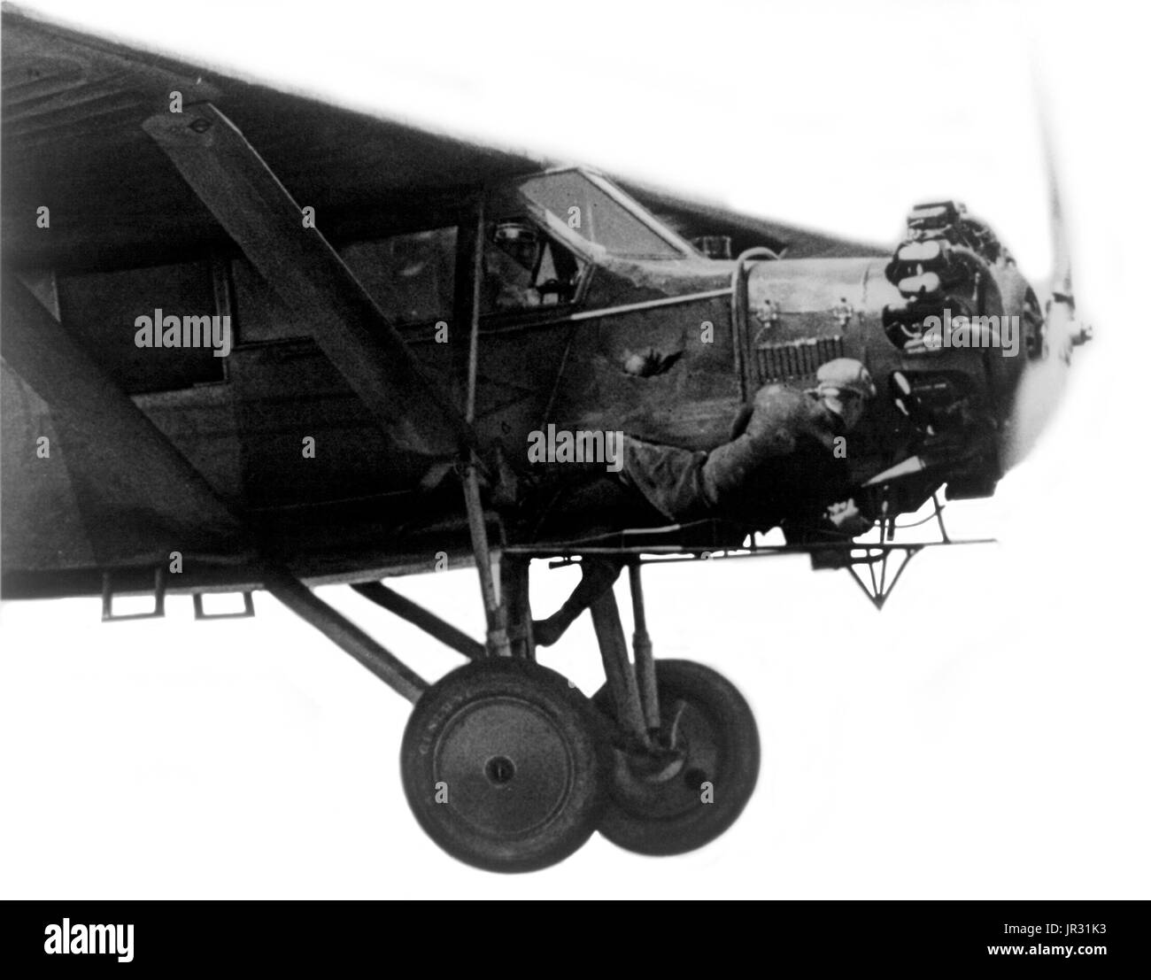 Kenneth Hunter lying down out on the cat-walk; gets his head awfully close to the propeller while brother John pilots the plane. Starting in airshows and barnstorming during the 1920s, wing walking is the act of moving on the wings of an airplane during flight. Wing walking was seen as an extreme form of barnstorming, and wing walkers would constantly take up the challenge of outdoing one another. They themselves admitted that the point of their trade was to make money on the audience's prospect of possibly watching someone die. Some of the many aerialists to become popular were Tiny Broderick Stock Photo