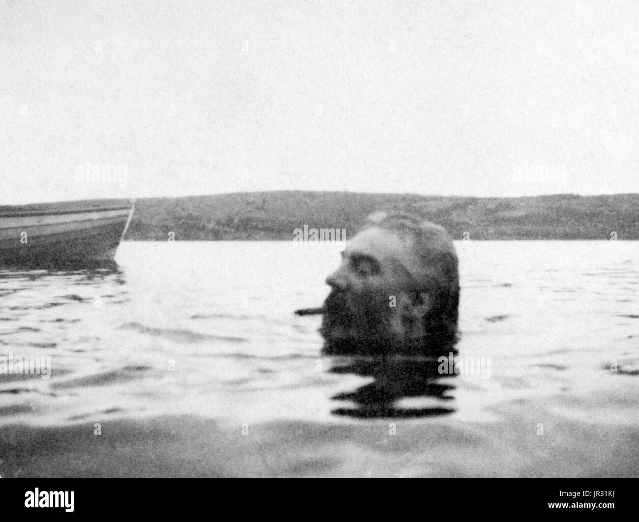 Bell swimming, his head above water, with cigar in his mouth. Alexander Graham Bell (March 3, 1847 - August 2, 1922) was a Scottish-American speech therapist and inventor of the telephone. Bell followed his father and grandfather into the speech therapy profession, but also studied sound waves and the mechanics of speech. By 1871, he had moved to the United States, becoming professor of vodal physiology in Boston. There he performed his experiments in converting sound waves into electrical impulses for transmission down wires. In 1876, he patented the telephone and founded what has become the  Stock Photo