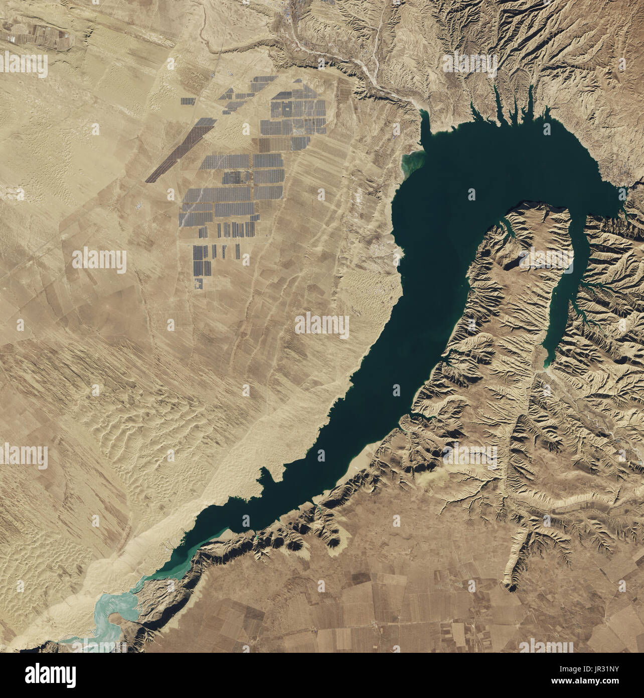 Longyangxia Dam Solar Park in China, the largest solar farm in the world as of February 2017, captured by the Operational Land Imager (OLI) on Landsat 8. Water in the dam's reservoir is used for irrigation and hydroelectric power. Stock Photo