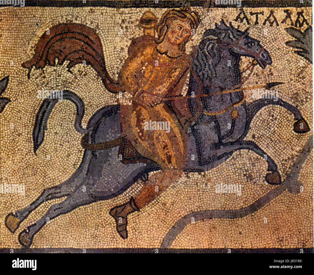 Panel from a mosaic pavement: Atalanta, on horseback, hunts a lion. The lion and the end of the Greek inscription giving Atalanta's name are missing. From a Roman Villa at Halicarnassus, 4th century AD. Atalanta is a character in Greek mythology, a virgin huntress, unwilling to marry, and loved by the hero Meleager. Having grown up in the wilderness, Atalanta became a fierce hunter and was always happy. She took an oath of virginity to the goddess Artemis. Halicarnassus was an ancient Greek city at the site of modern Bodrum in Turkey. The city was famous for the tomb of Mausolus, the origin of Stock Photo