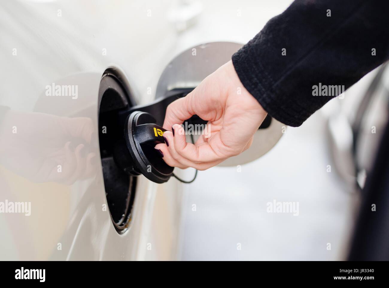Woman opening diesel fuel cap at the gas station Stock Photo