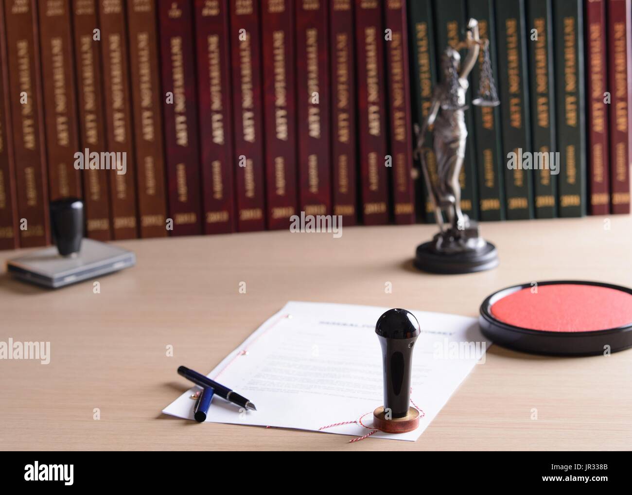 Signed by a notary public document with his stamp and pen. Themis with ...