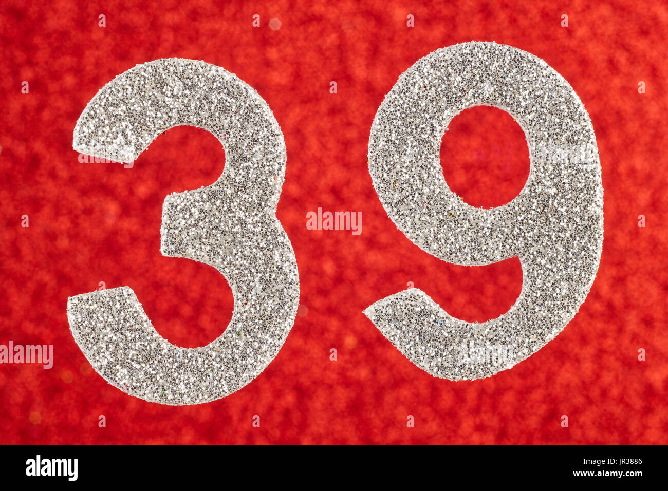Number thirty-nine silver color over a red background. Anniversary. Horizontal Stock Photo