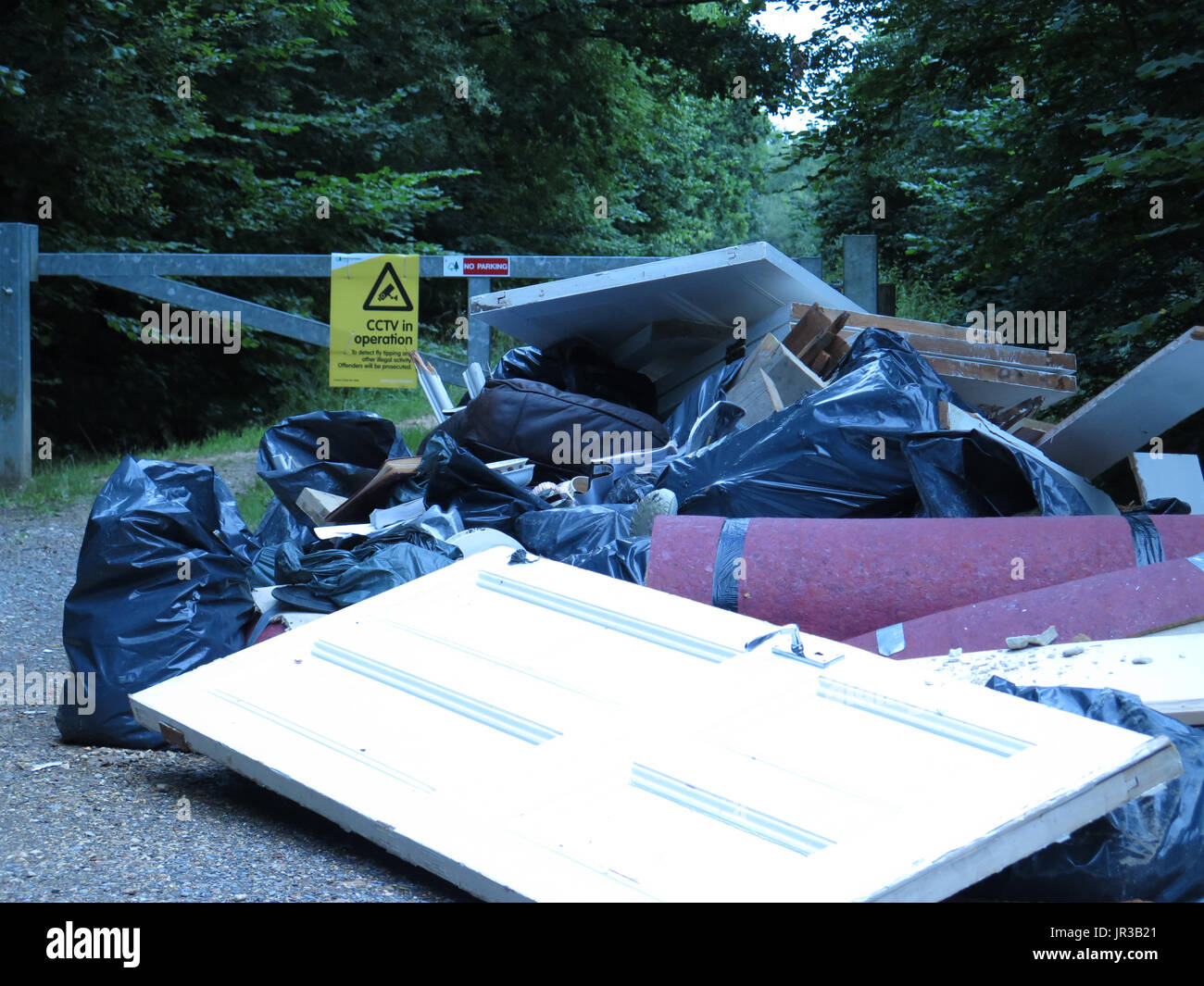fly tipping under CCTV sign Stock Photo Alamy