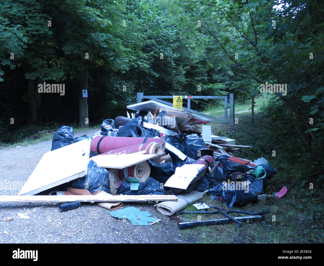 fly tipping under CCTV sign Stock Photo Alamy