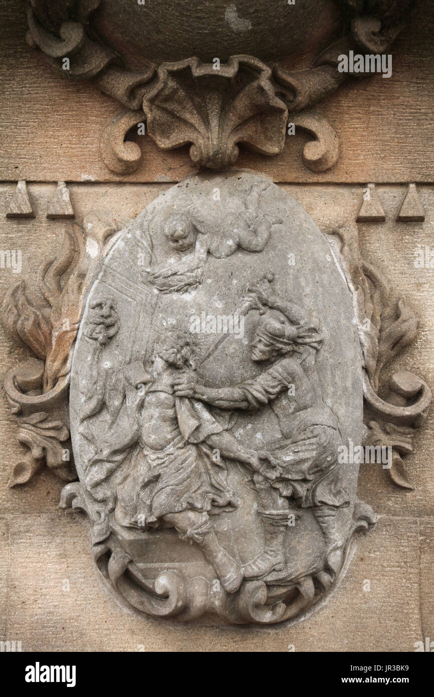 Assassination of Saint Wenceslaus. Relief on the pedestal of the Baroque statue of Saint Ludmila and Saint Wenceslaus on the Charles Bridge in Prague, Czech Republic. The original from 1720 carved in the workshop of Austrian-Bohemian Baroque sculptor Matthias Bernhard Braun was replaced by a copy in the beginning of the 21st century. Stock Photo