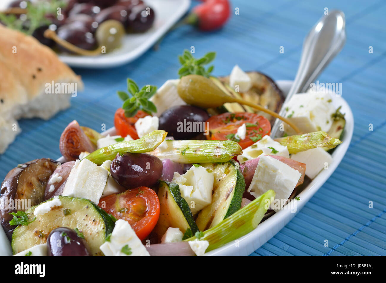 Greek fried vegetables with feta cheese and Kalamata olives, pita bread