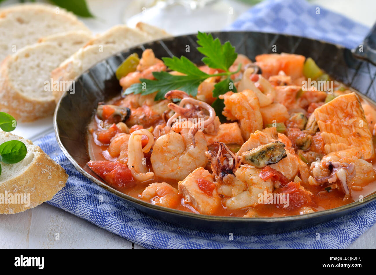 Seafood ragout with spicy tomato sauce in a pan Stock Photo - Alamy