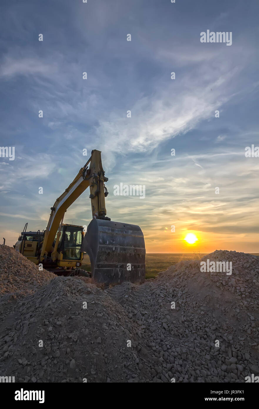 excavator in construction site at stunning sunset Stock Photo - Alamy