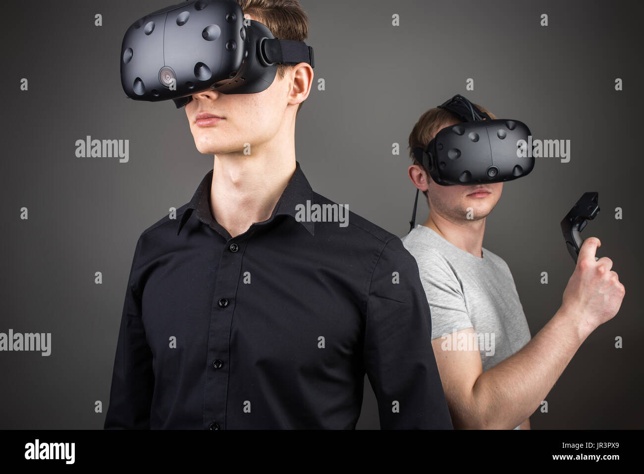 two young man playing game using virtual reality headset Stock Photo