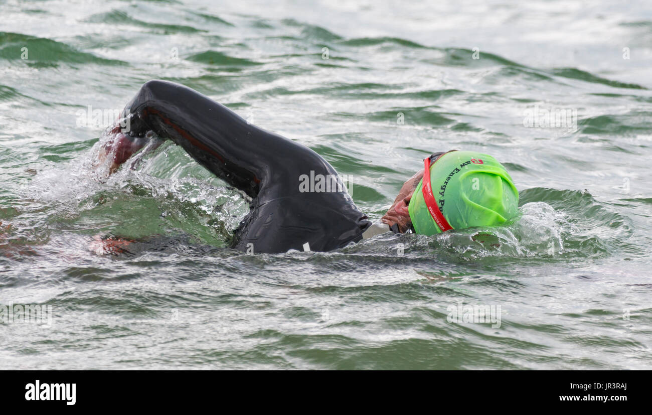 Swimming in the sea. Man training by swimming in the sea. Swimming practice. Stock Photo
