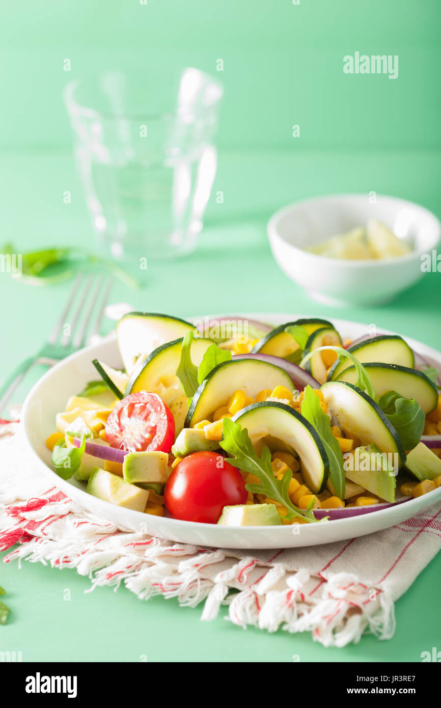 spiralized courgette salad with sweetcorn tomato avocado, healthy vegan meal Stock Photo