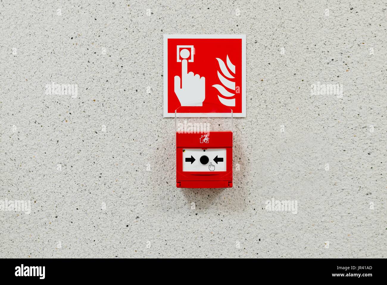 Red fire alarm button installed on the wall Stock Photo